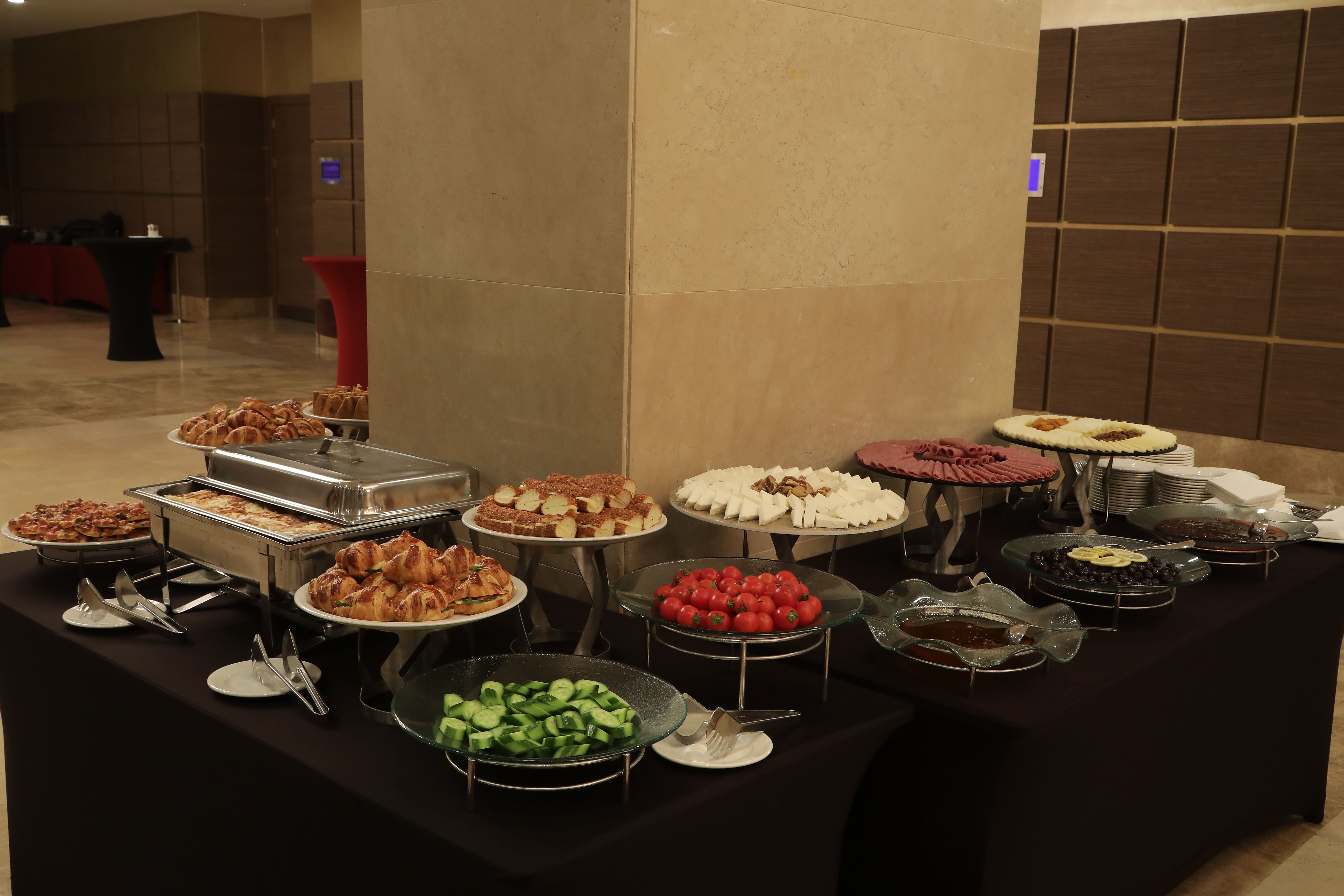 A buffet table laden with a variety of desserts and appetizers at an event.